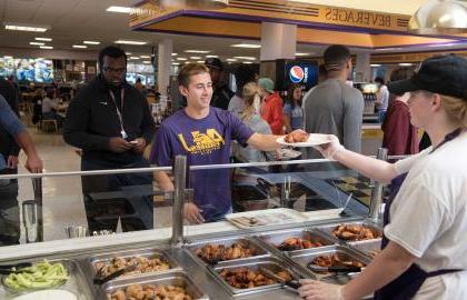 Student being served food in Convo