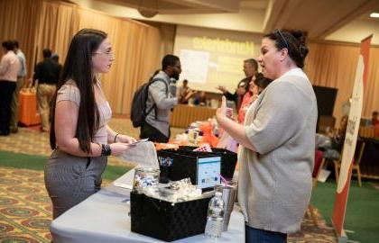 Student at career fair talking with recruiter